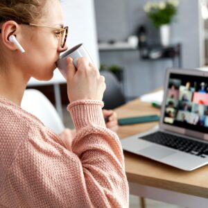 Woman on webinar drinking coffee