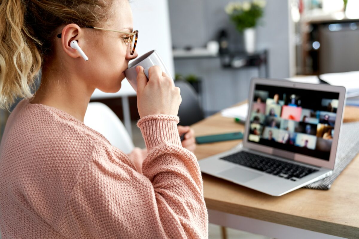 Woman on webinar drinking coffee